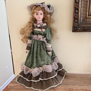 Elegant Green and Brown Porcelain Doll